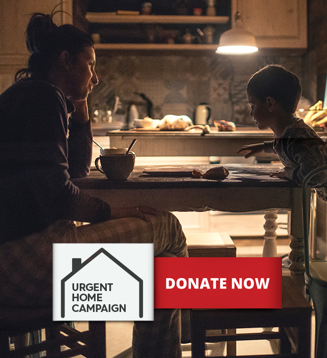 Urgent Home Campaign. Mother and child at kitchen table.